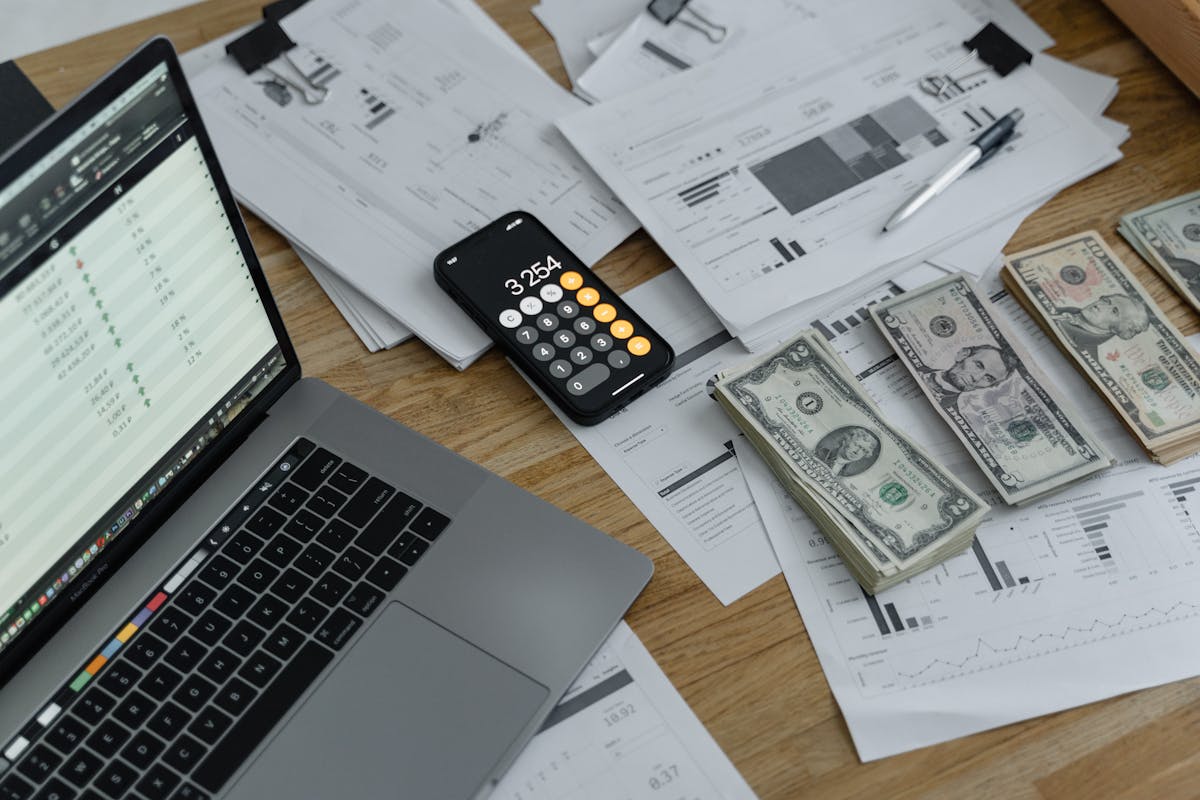 Bookkeeping documents and laptop on a desk