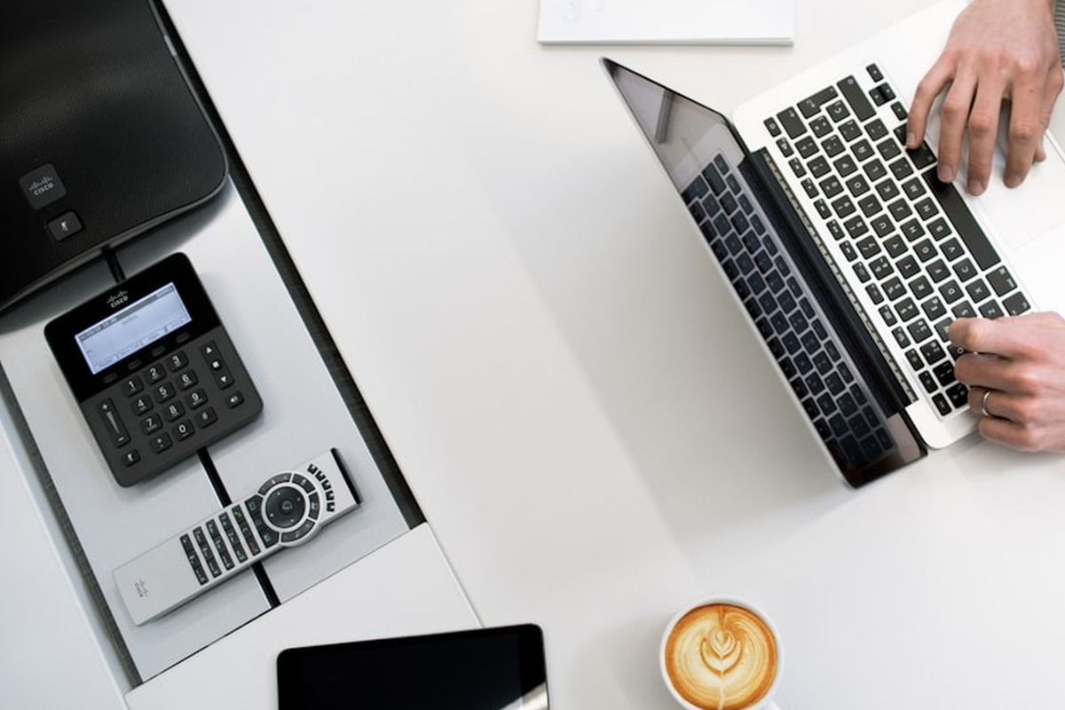 Owner-managed business workspace with laptop and coffee prepared for planning
