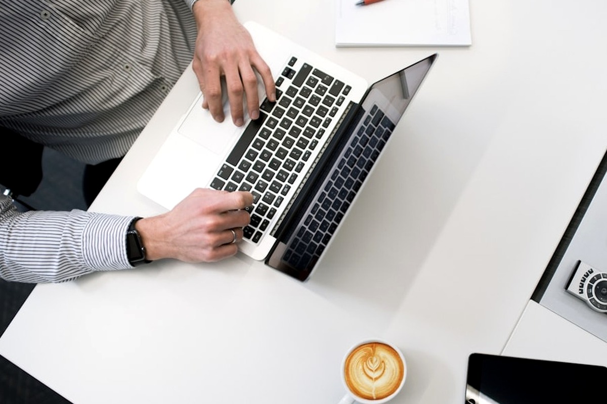 Business planning desk with laptop, tablet, and work notes
